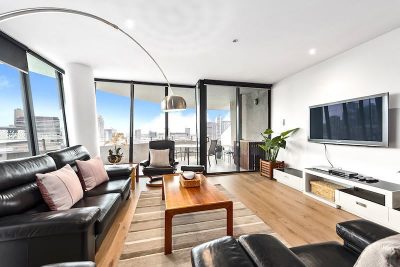 Large lounge and balcony with views of Docklands