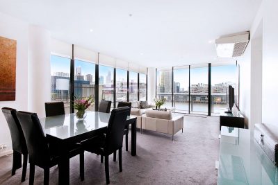 Large open-plan lounge/living area, dining table, lounge, which opens onto a private balcony